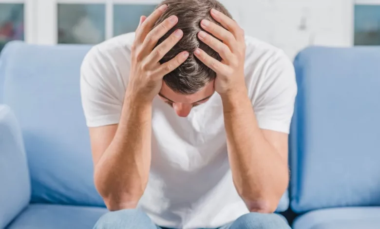 Frustrated Man Suffering From Headache Sitting Sofa