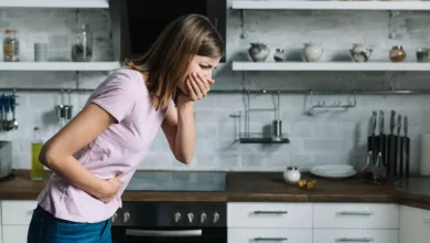 Sick Woman Suffering From Nausea Standing Kitchen.jpg