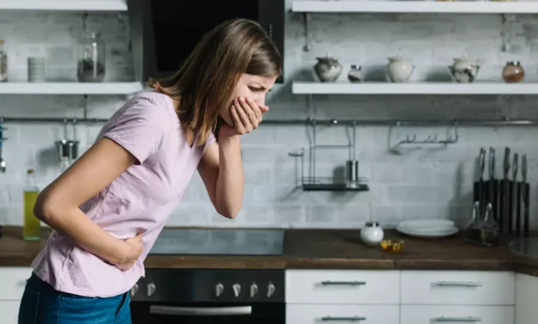 Sick Woman Suffering From Nausea Standing Kitchen.jpg